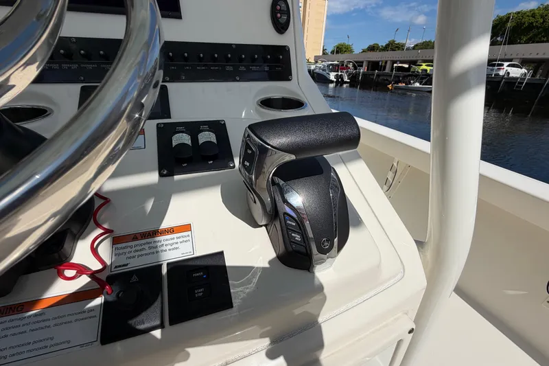 Slide: The Image of Control panel of a 2022 Pathfinder 2600 HPS boat, featuring throttle and steering wheel. - 32