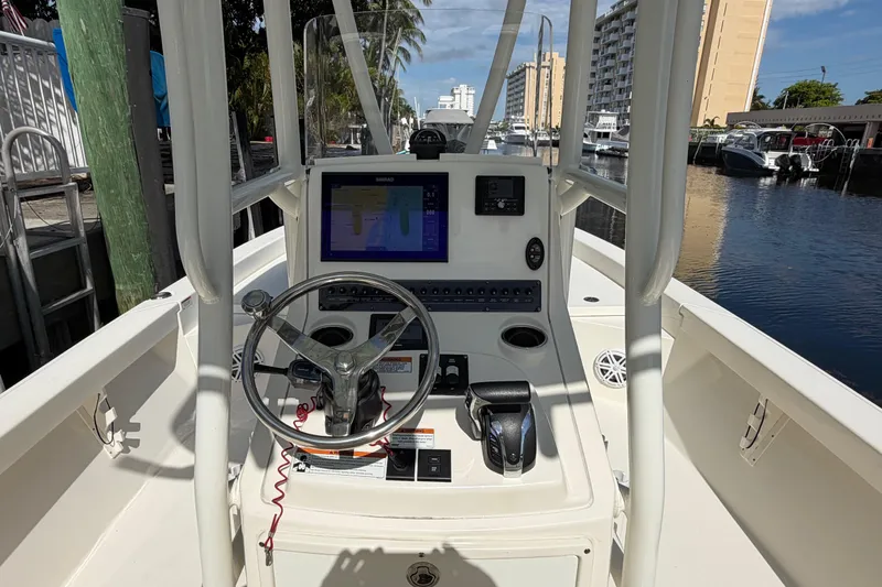 Slide: The Image of 2022 Pathfinder 2600 HPS boat console with steering wheel and navigation display. - 33