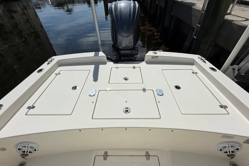 Slide: The Image of 2022 Pathfinder 2600 HPS boat with storage compartments and outboard motor at dock. - 38