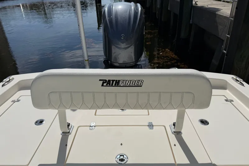 Slide: The Image of 2022 Pathfinder 2600 HPS boat with outboard motor, docked by the water. - 40