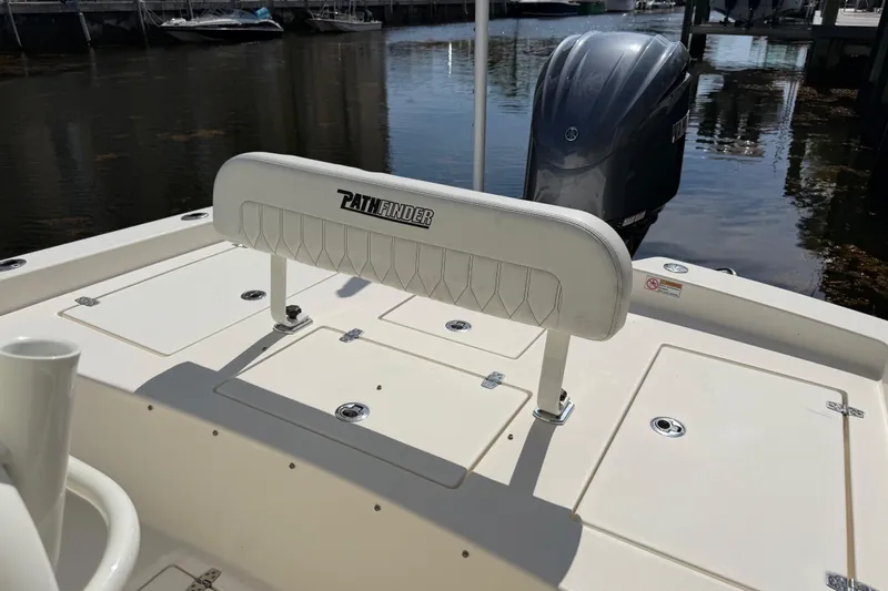 Slide: The Image of 2022 Pathfinder 2600 HPS boat deck with seating and outboard motor in marina. - 41