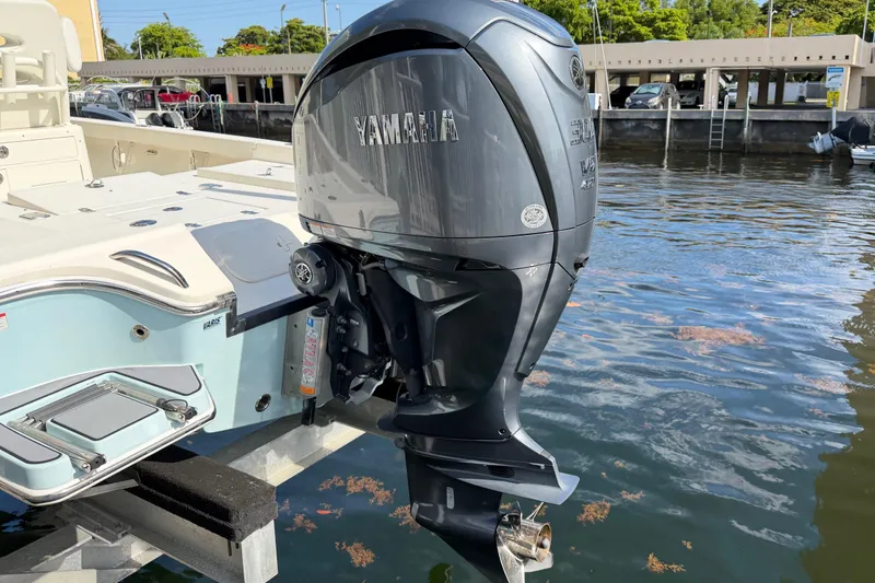 Slide: The Image of 2022 Pathfinder 2600 HPS boat with Yamaha outboard motor docked by the water. - 7