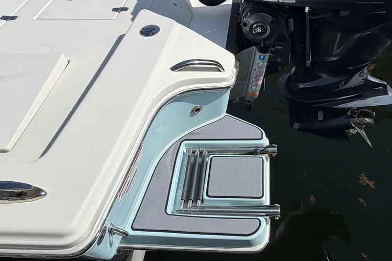 Slide: The Image of 2022 Pathfinder 2600 HPS boat with swim platform and outboard motor in water. - 9