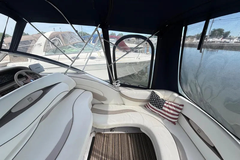 Slide: The Image of Interior of 1998 Four Winns 258 Vista boat with American flag pillow. - 10