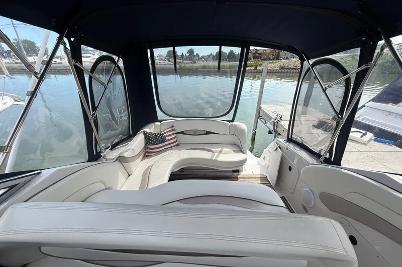 Slide: The Image of 1998 Four Winns 258 Vista boat interior with seating and American flag pillow. - 11