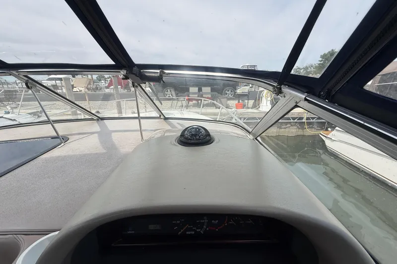 Slide: The Image of Interior view of 1998 Four Winns 258 Vista boat cockpit with compass and dashboard. - 15