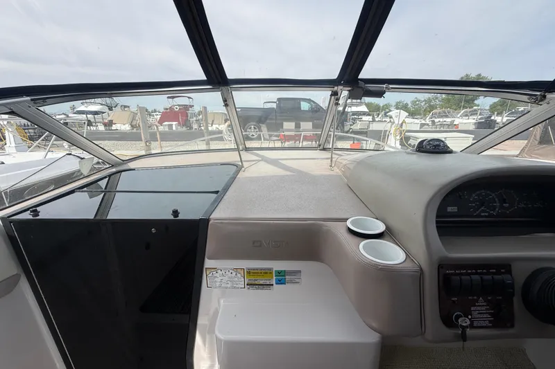 Slide: The Image of Interior view of a 1998 Four Winns 258 Vista boat cockpit with dashboard and controls. - 16