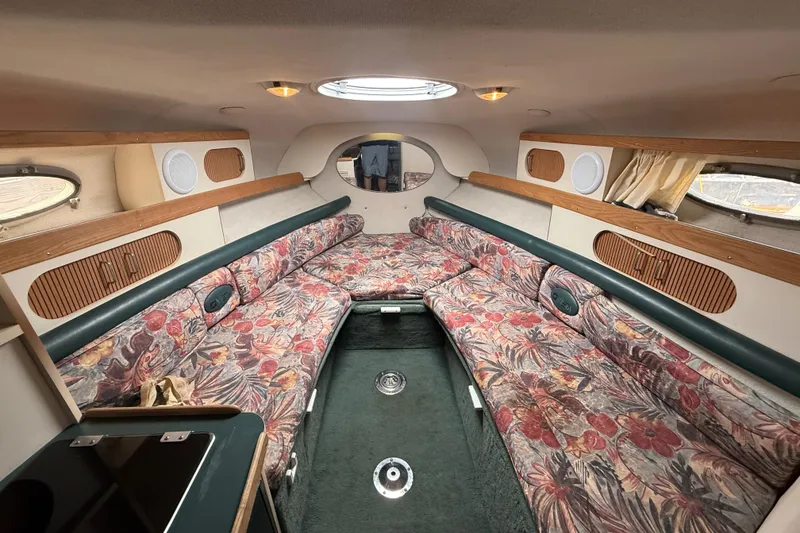 Slide: The Image of Interior of 1998 Four Winns 258 Vista boat with floral upholstery and wood accents. - 19