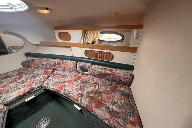 Slide: The Image of Interior of 1998 Four Winns 258 Vista boat with floral upholstery and wood accents. - 21