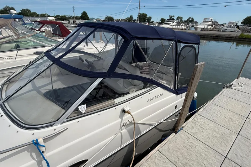 Slide: The Image of 1998 Four Winns 258 Vista boat docked with blue canopy in marina. - 4