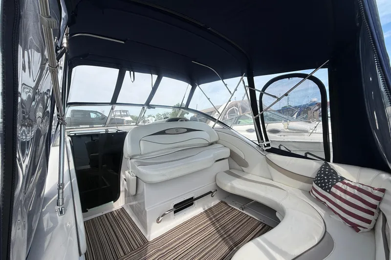 Slide: The Image of Interior of 1998 Four Winns 258 Vista boat with seating and American flag pillow. - 6