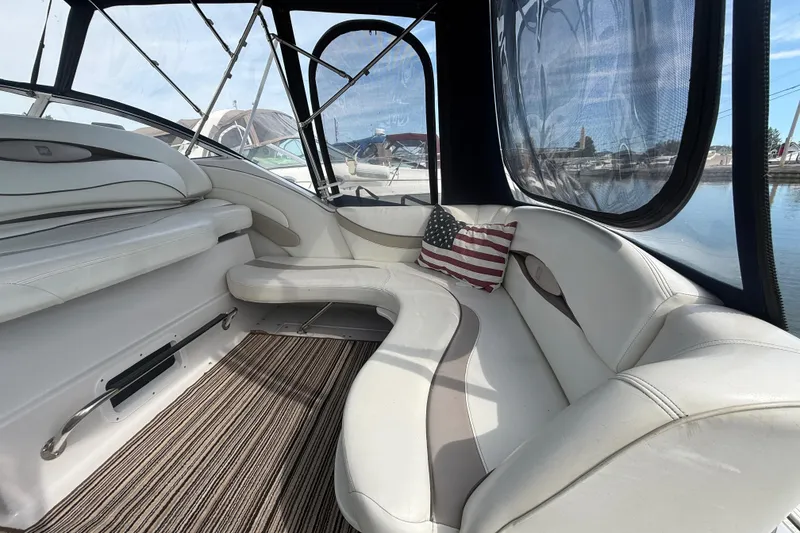 Slide: The Image of Interior of 1998 Four Winns 258 Vista boat with white seating and American flag pillow. - 7