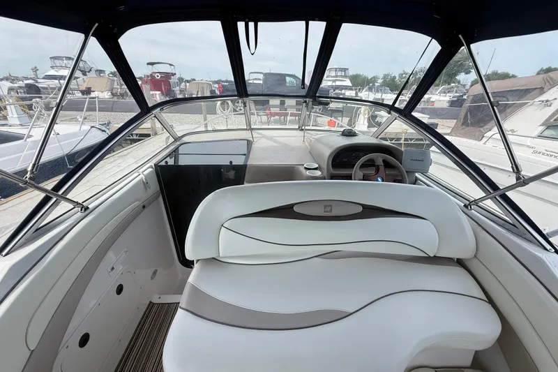 Slide: The Image of 1998 Four Winns 258 Vista boat interior with steering wheel and seating area. - 8