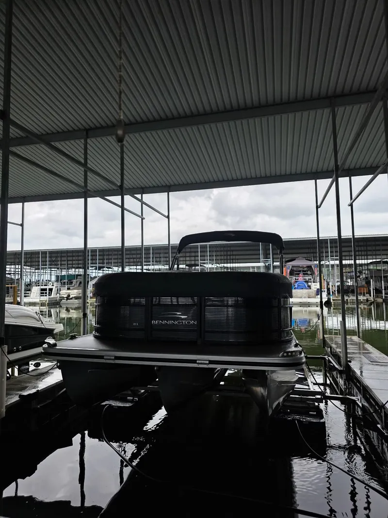 Slide: The Image of Bennington 25LSB 2022 pontoon boat docked under a canopy. - 0