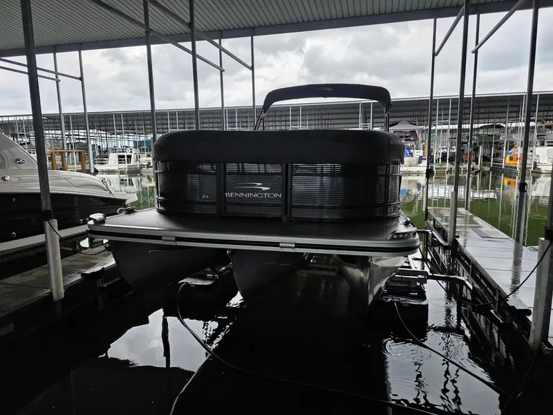 Slide: The Image of Bennington 25LSB 2022 pontoon boat docked, cloudy sky. - 2