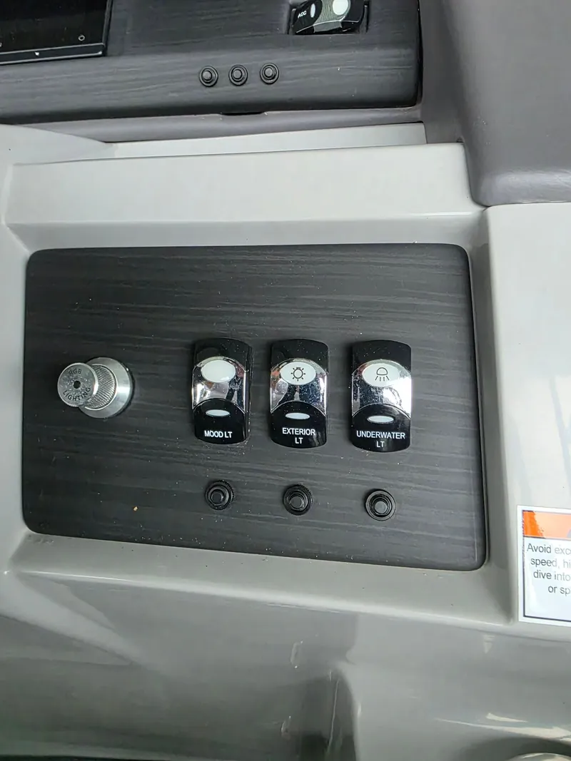 Slide: The Image of Control panel of a 2022 Bennington 25LSB with light switches. - 21