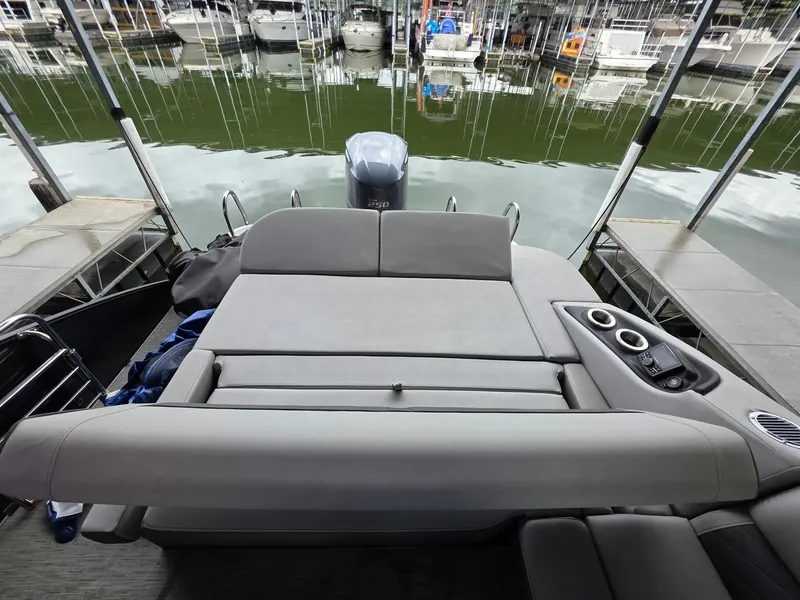 Slide: The Image of Bennington 25LSB 2022 pontoon boat at dock with gray seating. - 25