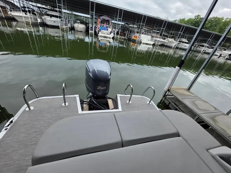 Slide: The Image of Bennington 25LSB 2022 at dock with outboard motor. - 31