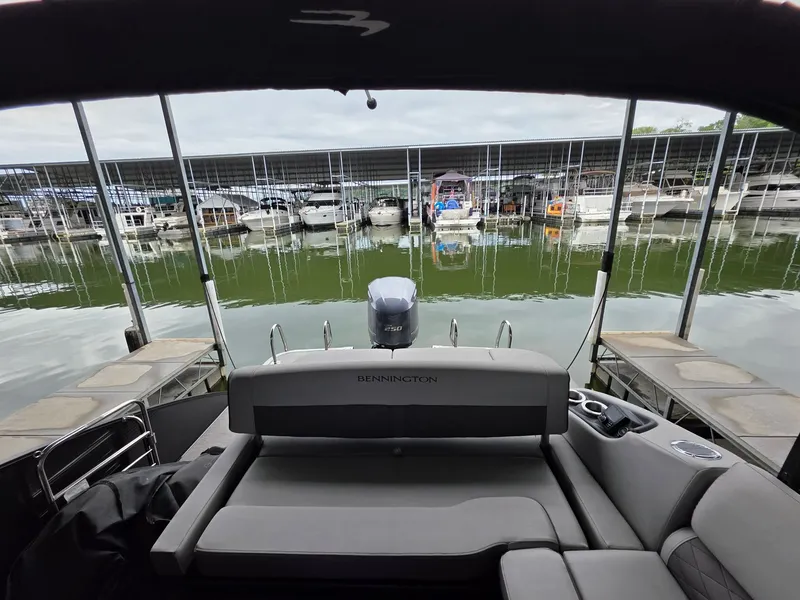 Slide: The Image of Bennington 25LSB 2022 boat docked with other boats in marina. - 32