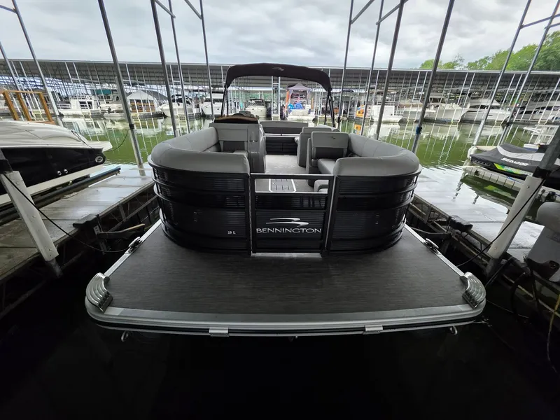 Slide: The Image of 2022 Bennington 25LSB pontoon boat docked at marina. - 34