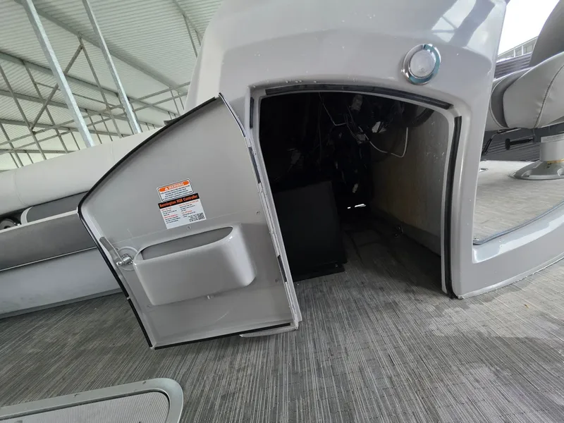 Slide: The Image of Open compartment door of a 2022 Bennington 25LSB boat. - 38