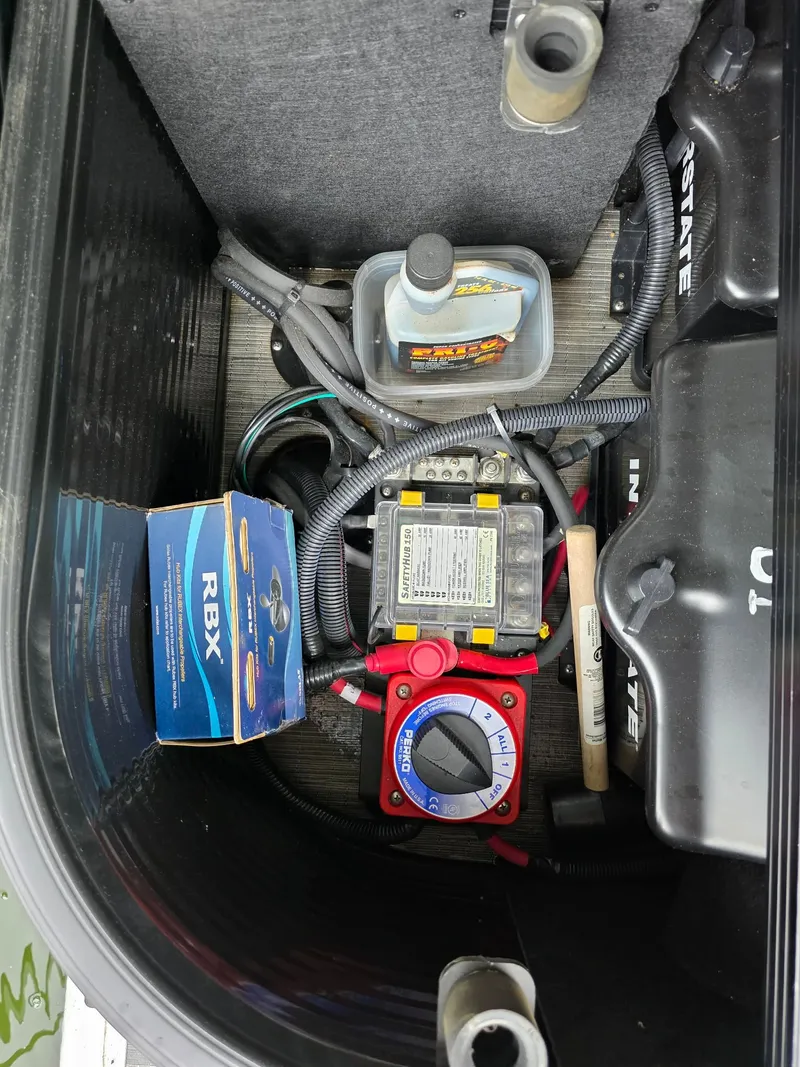 Slide: The Image of Storage compartment of a Bennington 25LSB boat with accessories and tools. - 43