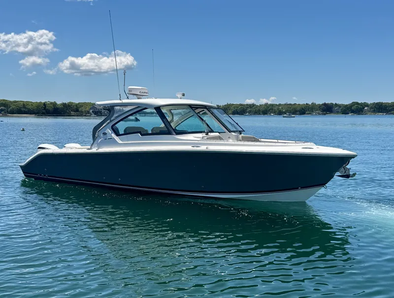 The Image of 2021 Pursuit 326 DC boat on calm water. - 0