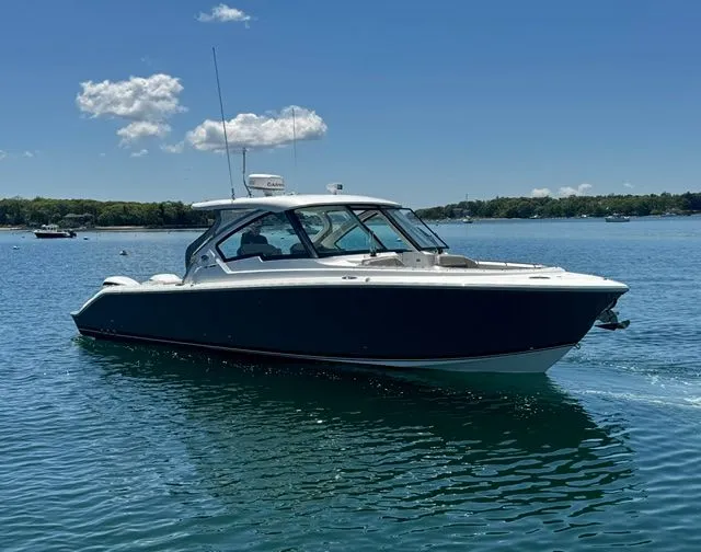 Slide: The Image of Pursuit 326 DC boat on calm water, 2021 model. - 1