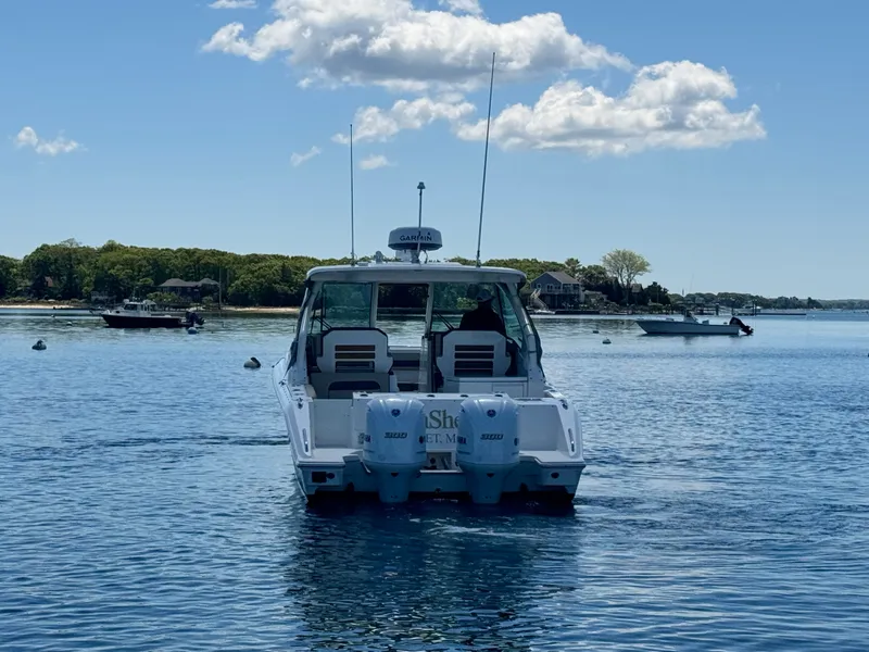 Slide: The Image of Pursuit 326 DC boat from 2021 on calm water. - 10