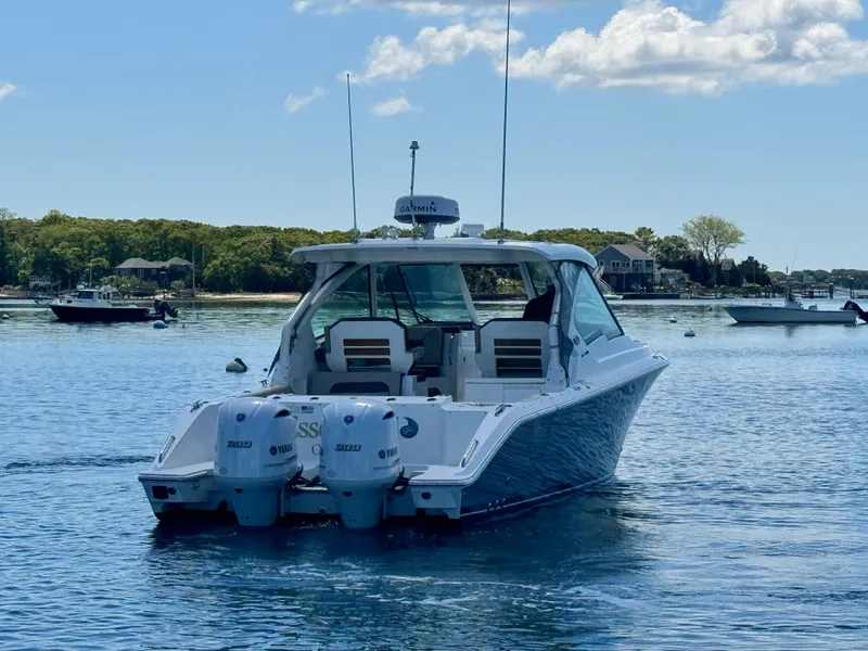 Slide: The Image of 2021 Pursuit 326 DC boat on calm water. - 11