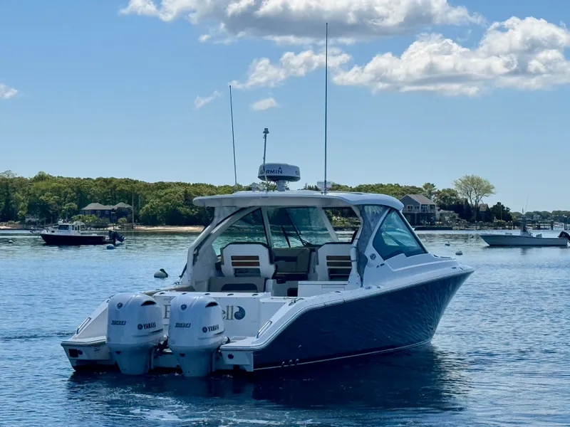 Slide: The Image of Pursuit 326 DC 2021 boat on calm water with blue sky. - 12