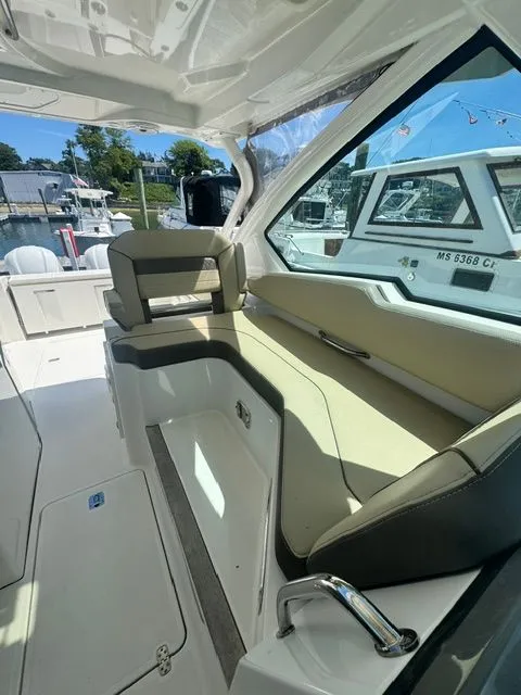 Slide: The Image of Interior of a 2021 Pursuit 326 DC boat with beige seating area. - 23