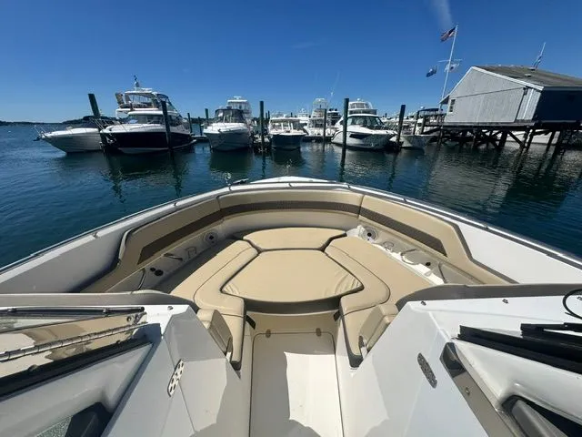 Slide: The Image of Pursuit 326 DC 2021 boat docked with other yachts. - 24