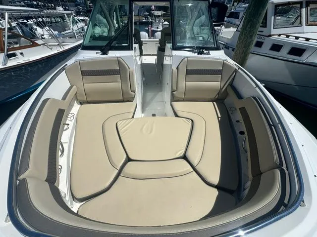 Slide: The Image of Interior view of a 2021 Pursuit 326 DC boat with beige seating. - 25
