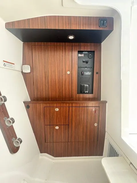 Slide: The Image of Interior view of 2021 Pursuit 326 DC with wood paneling. - 27