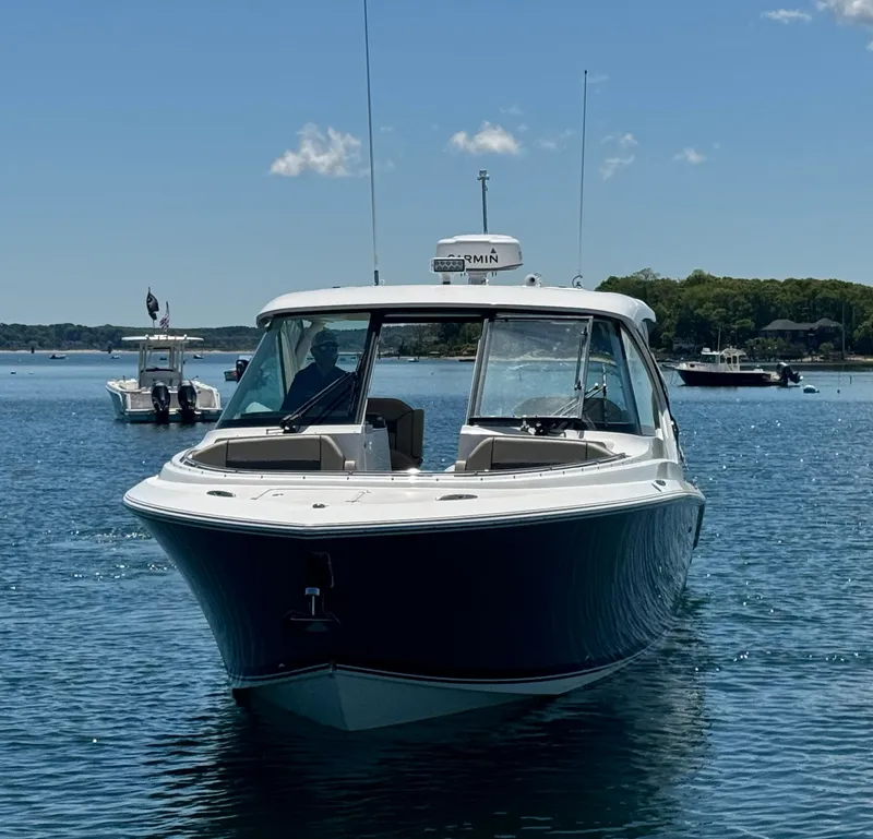 Slide: The Image of 2021 Pursuit 326 DC boat on calm water. - 3