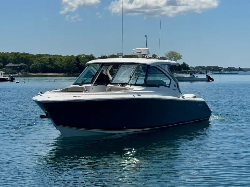Slide: The Image of 2021 Pursuit 326 DC boat on calm water. - 5