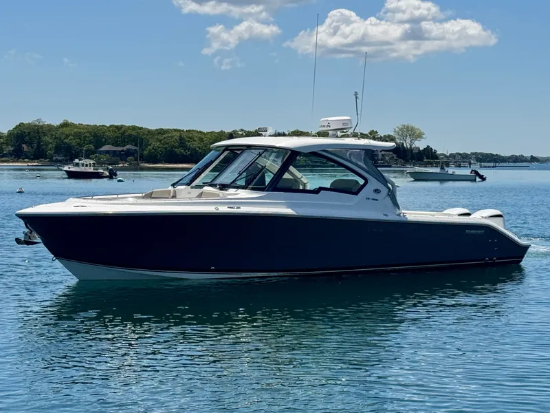 Slide: The Image of 2021 Pursuit 326 DC boat on calm water. - 6