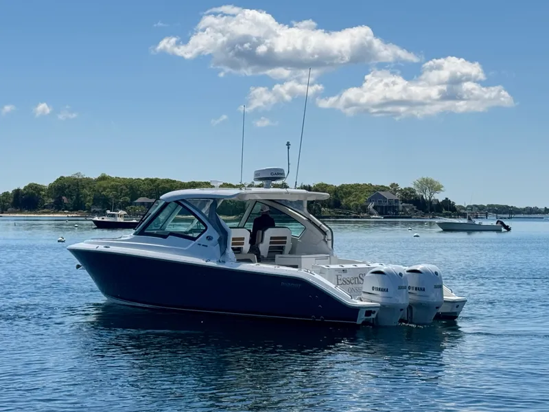 Slide: The Image of 2021 Pursuit 326 DC boat on calm water. - 9