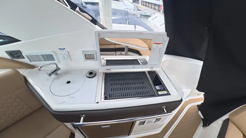 Slide: The Image of Galley of the 2025 Sea Ray Sundancer 320 Outboard with sink and grill. - 13