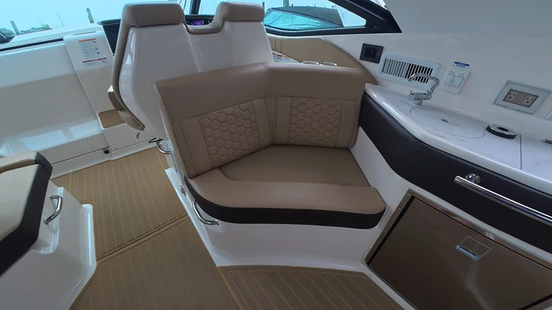 Slide: The Image of Interior of the Sea Ray Sundancer 320 Outboard with sleek seating and modern amenities. - 14