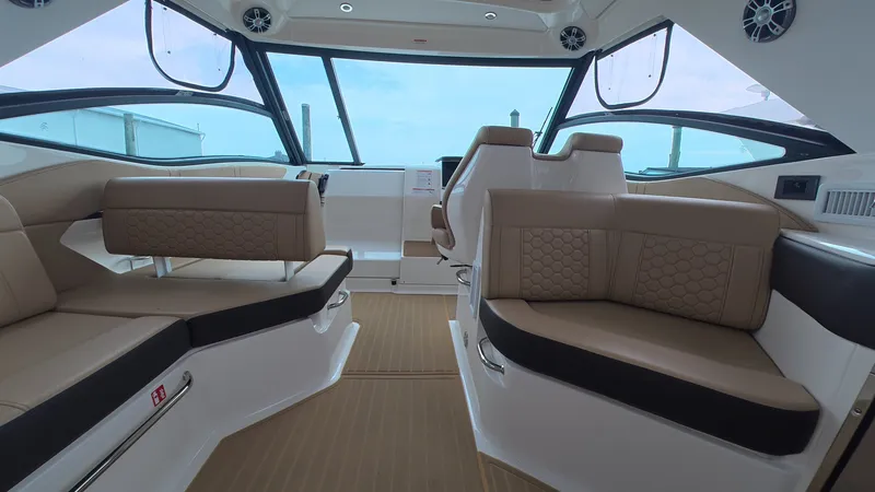 Slide: The Image of Interior of the Sea Ray Sundancer 320 Outboard with sleek seating and large windows. - 15