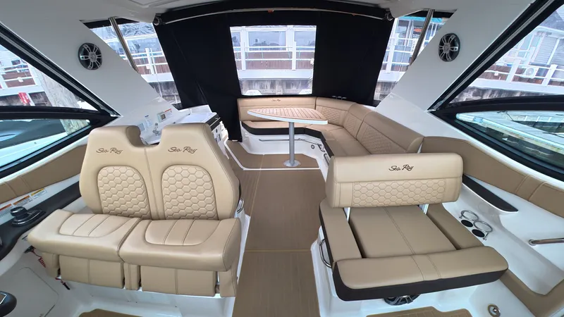 Slide: The Image of Interior of the 2025 Sea Ray Sundancer 320 Outboard with elegant seating and table. - 16