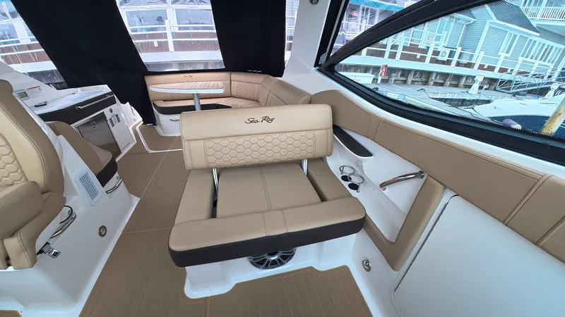 Slide: The Image of Interior of the Sea Ray Sundancer 320 Outboard with beige upholstery and modern fittings. - 17
