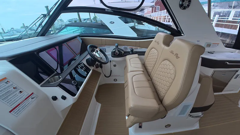 Slide: The Image of Interior of the 2025 Sea Ray Sundancer 320 Outboard with luxurious seating and modern cockpit. - 19