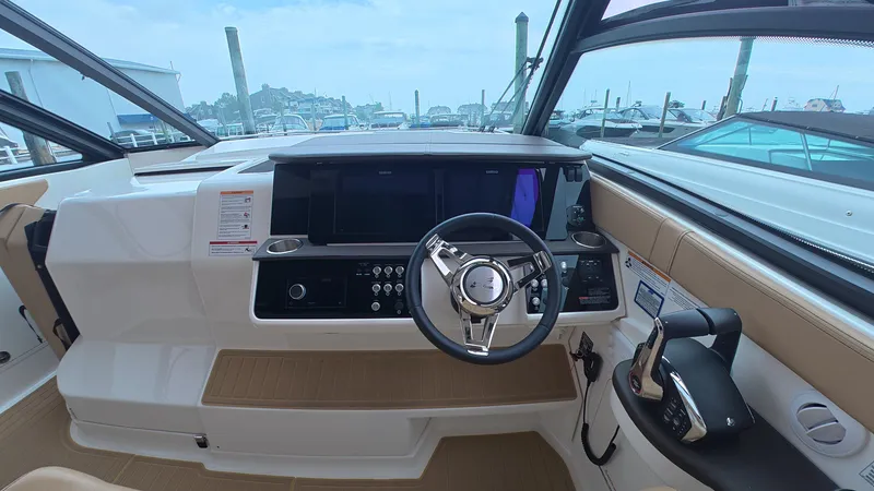 Slide: The Image of The cockpit of a Sea Ray Sundancer 320 Outboard with modern steering and instruments. - 20