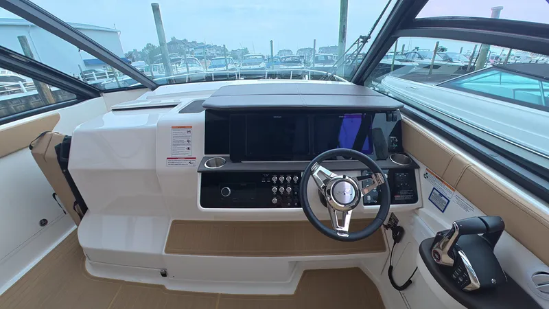 Slide: The Image of Cockpit of the 2025 Sea Ray Sundancer 320 Outboard with modern helm and electronics. - 21