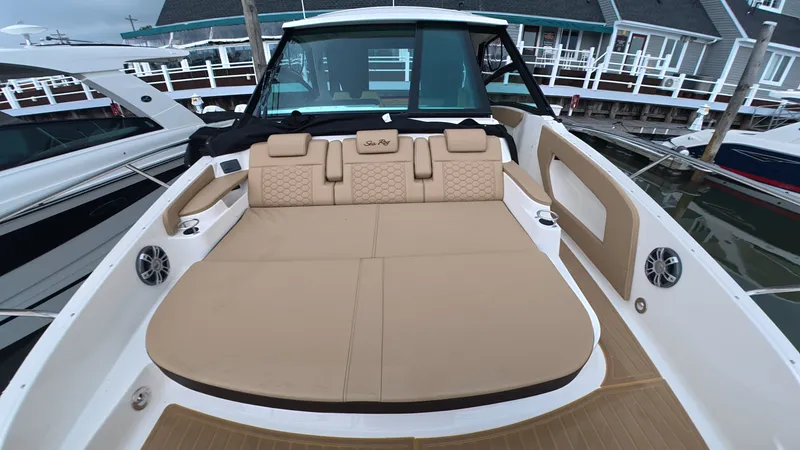 Slide: The Image of The image shows the cockpit of a Sea Ray Sundancer 320 Outboard with beige upholstery. - 23