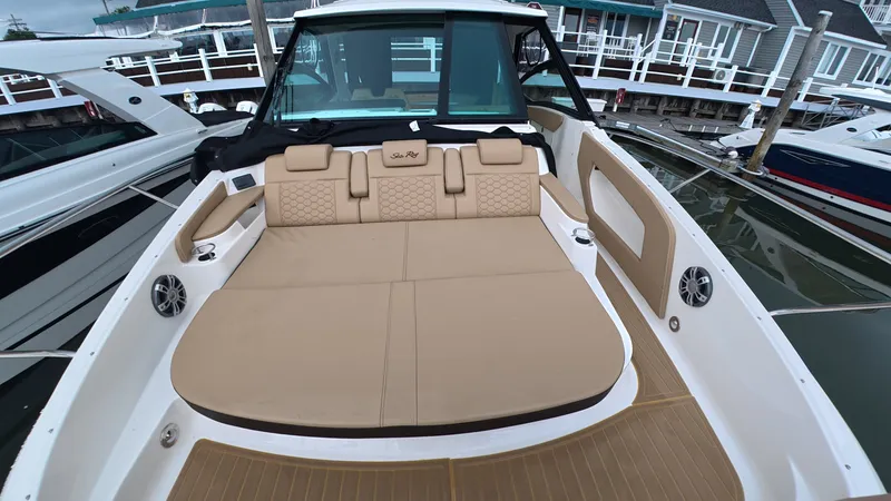 Slide: The Image of The image shows the deck of a 2025 Sea Ray Sundancer 320 Outboard with beige upholstery. - 24