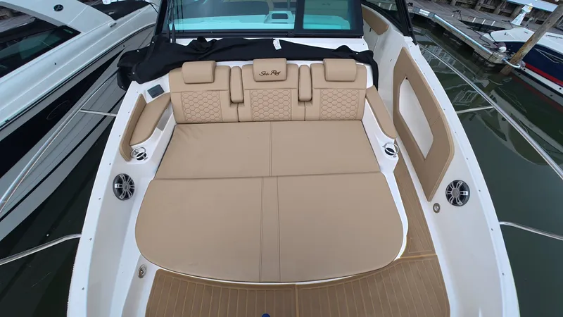 Slide: The Image of Rear view of a Sea Ray Sundancer 320 Outboard with beige cushioned seating area. - 25